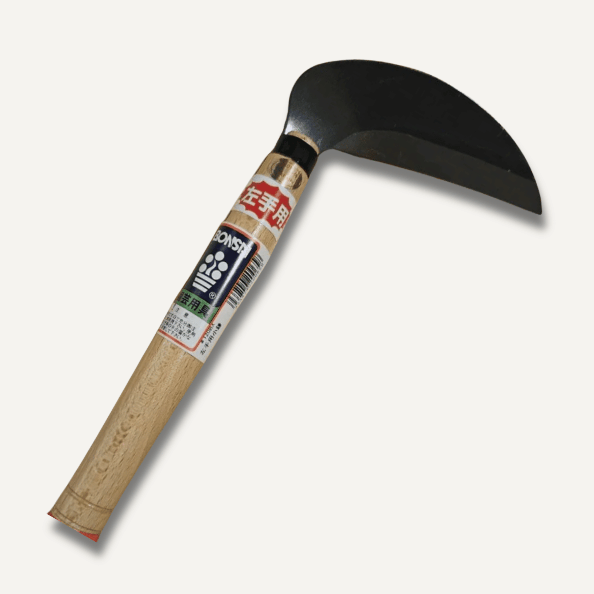 Left handed sickle with wooden handle and black blade on a white background