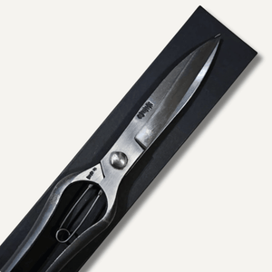 Shears with black handles and silver blades on a white background