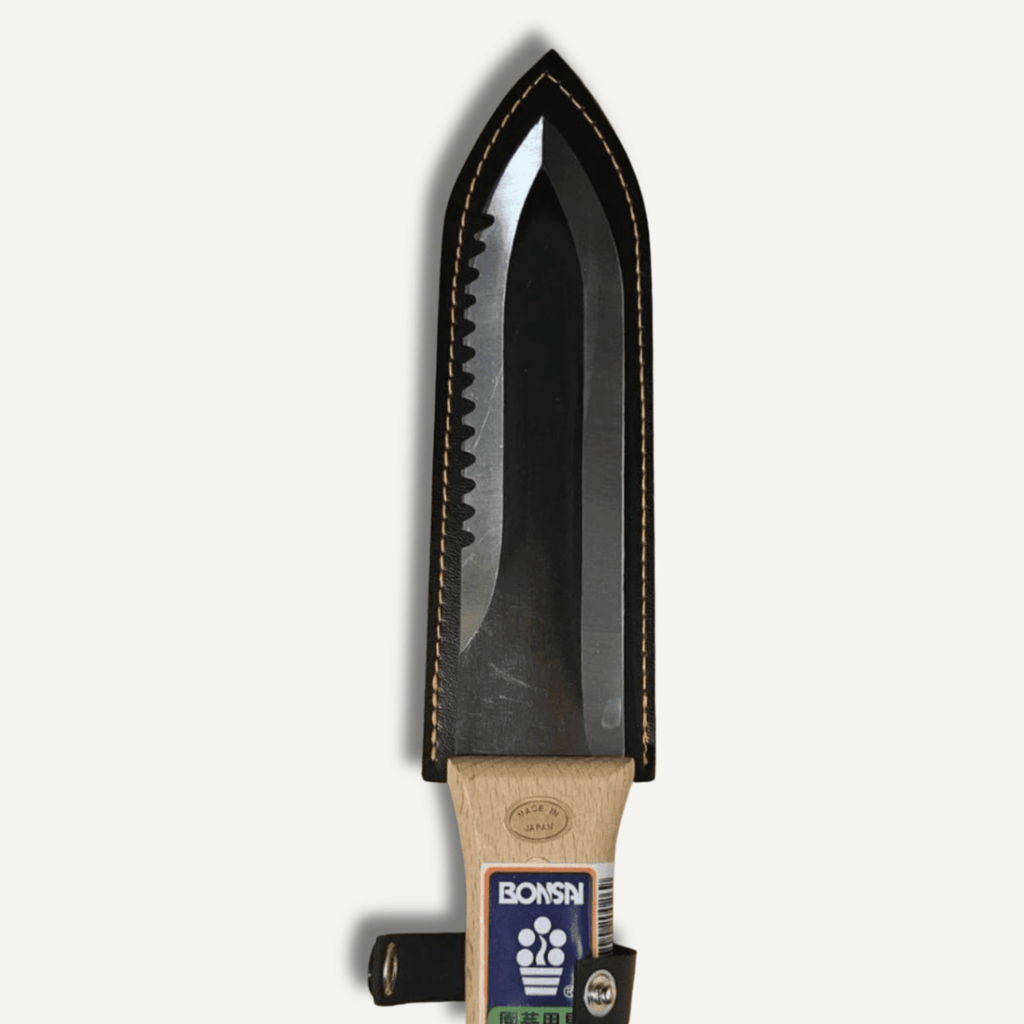 Hori Hori with a wooden handle and metal blade on a white background