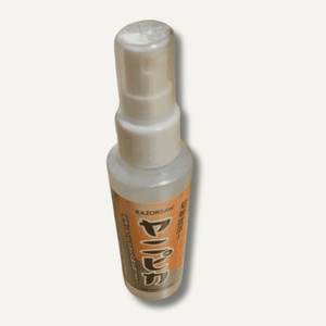 Spray bottle with an orange label on a white background