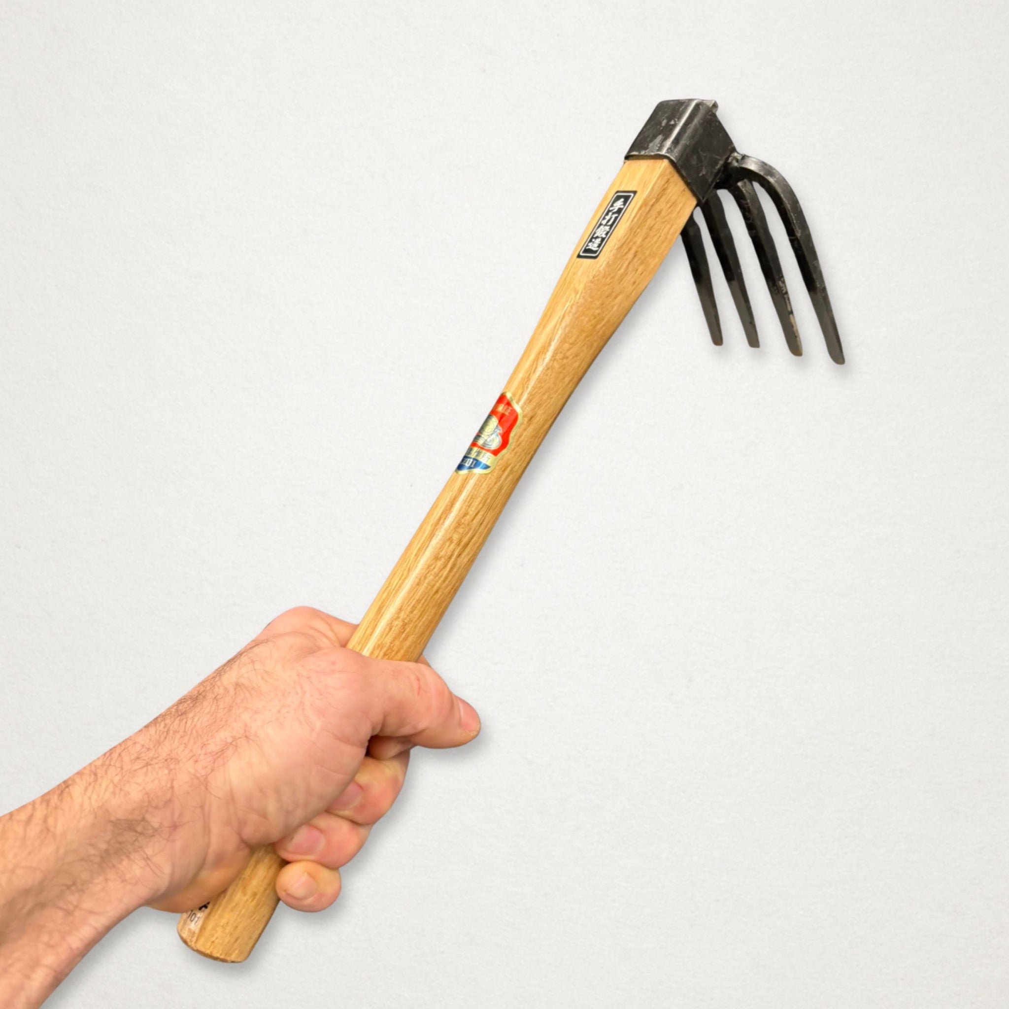 Azui No.101 Japanese four-tine hand hoe in hand for close weeding and soil cultivation