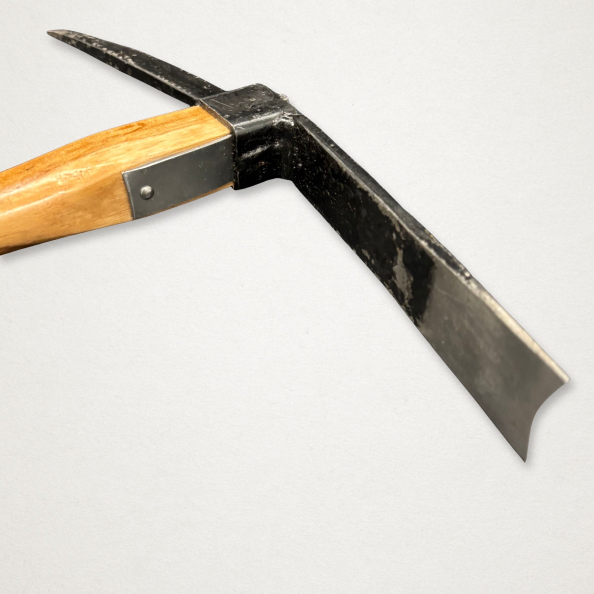 Close-up of Azui No.106 Japanese pick mattock showing flat blade and pointed pick for soil work