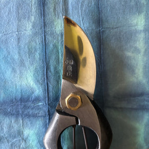Close-up of Tobisho Classic Type-A 200 mm pruning shears resting on indigo-dyed washi paper