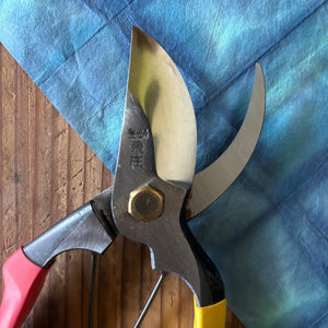 Close-up of Tobisho SR-1 pruning shears blade and joint, highlighting steel finish and rivet detail