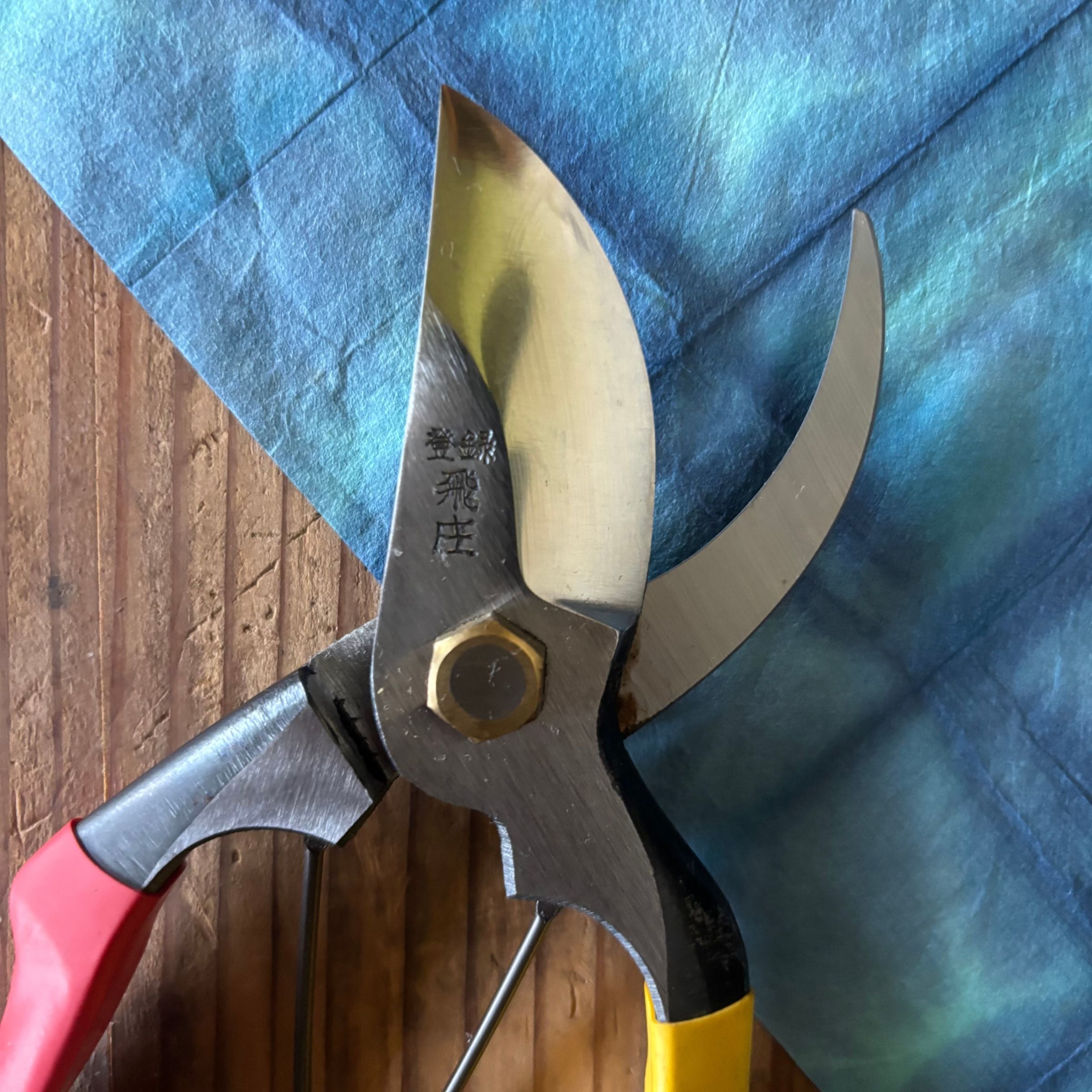Close-up of Tobisho SR-1 pruning shears blade and joint, highlighting steel finish and rivet detail