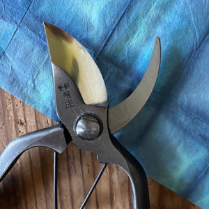 Close-up of Tobisho Type-B Pruning Shears 200mm blade and joint detail on indigo wash paper, Japanese forged Yasugi steel garden tool