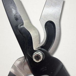 Close-up of Japanese hedge shears pivot area with polished blade faces, black forged body and Made in Japan stamp