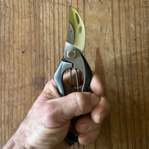 Hand holding Tobisho Classic Type-A 200 mm pruning shears, demonstrating ergonomic grip and handle design