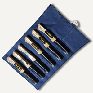 Ikeuchi hamono 6 piece carving knife set on blue canvas wrap with blade sheaths on blades