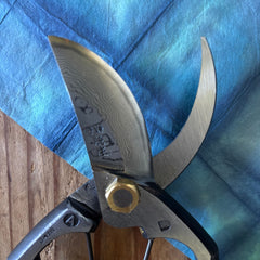 Macro detail of Damascus layers and brass joint on Tobisho Type-A Yasugi Blue Steel secateurs