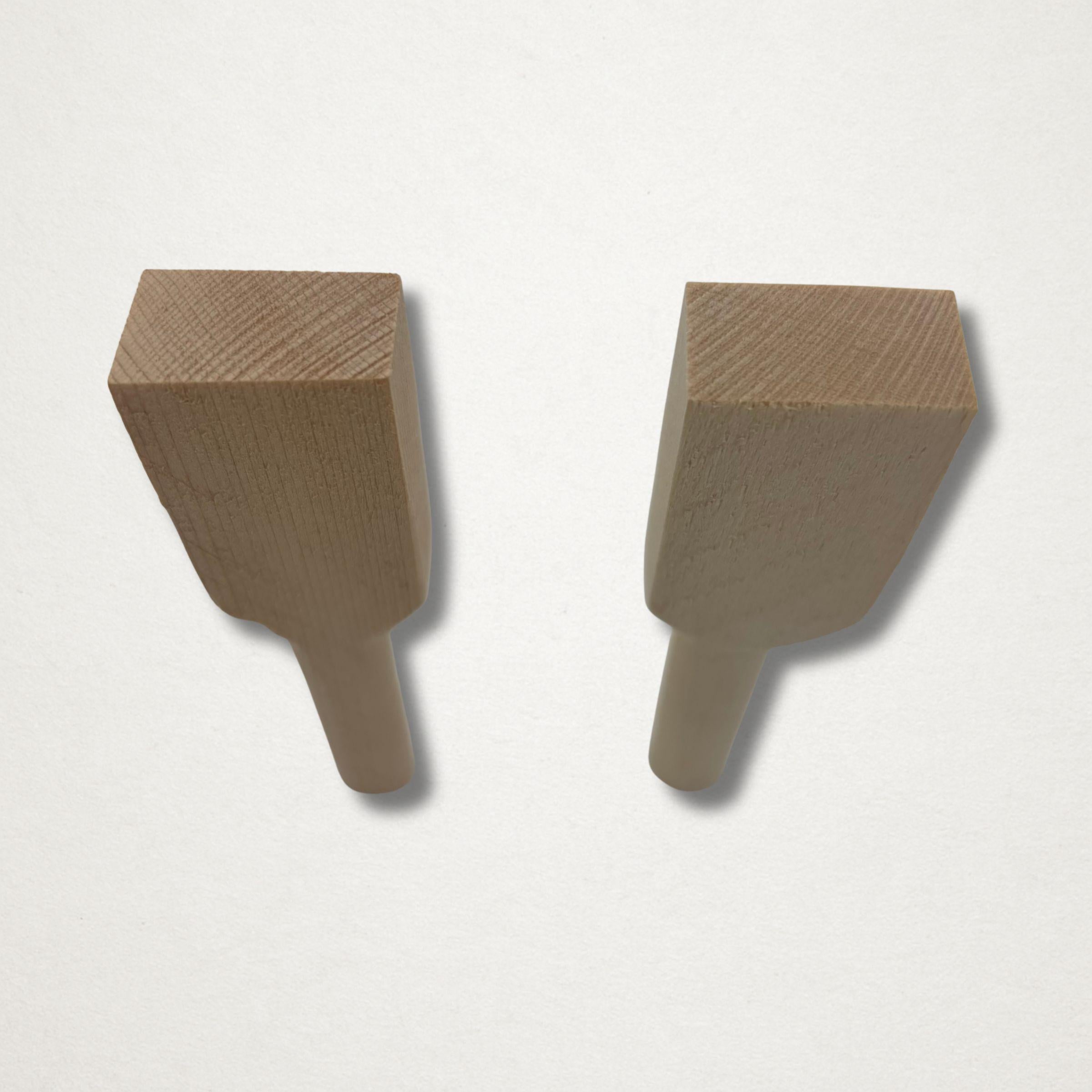 Angled close-up of hinoki teaspoon blank pair on a white background