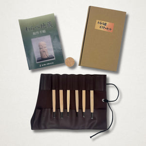 Complete Michi Hamono Little Jizo carving kit with boxed set, booklet, wood blank, and tools in open tool roll