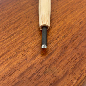 Close-up of a small carving tool from the Michi Hamono Little Jizo carving kit with a light wood handle