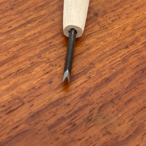 Close-up of a narrow V-gouge carving tool from the Michi Hamono Little Jizo carving kit