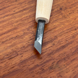 Close-up of an angled knife carving tool from the Michi Hamono Little Jizo carving kit