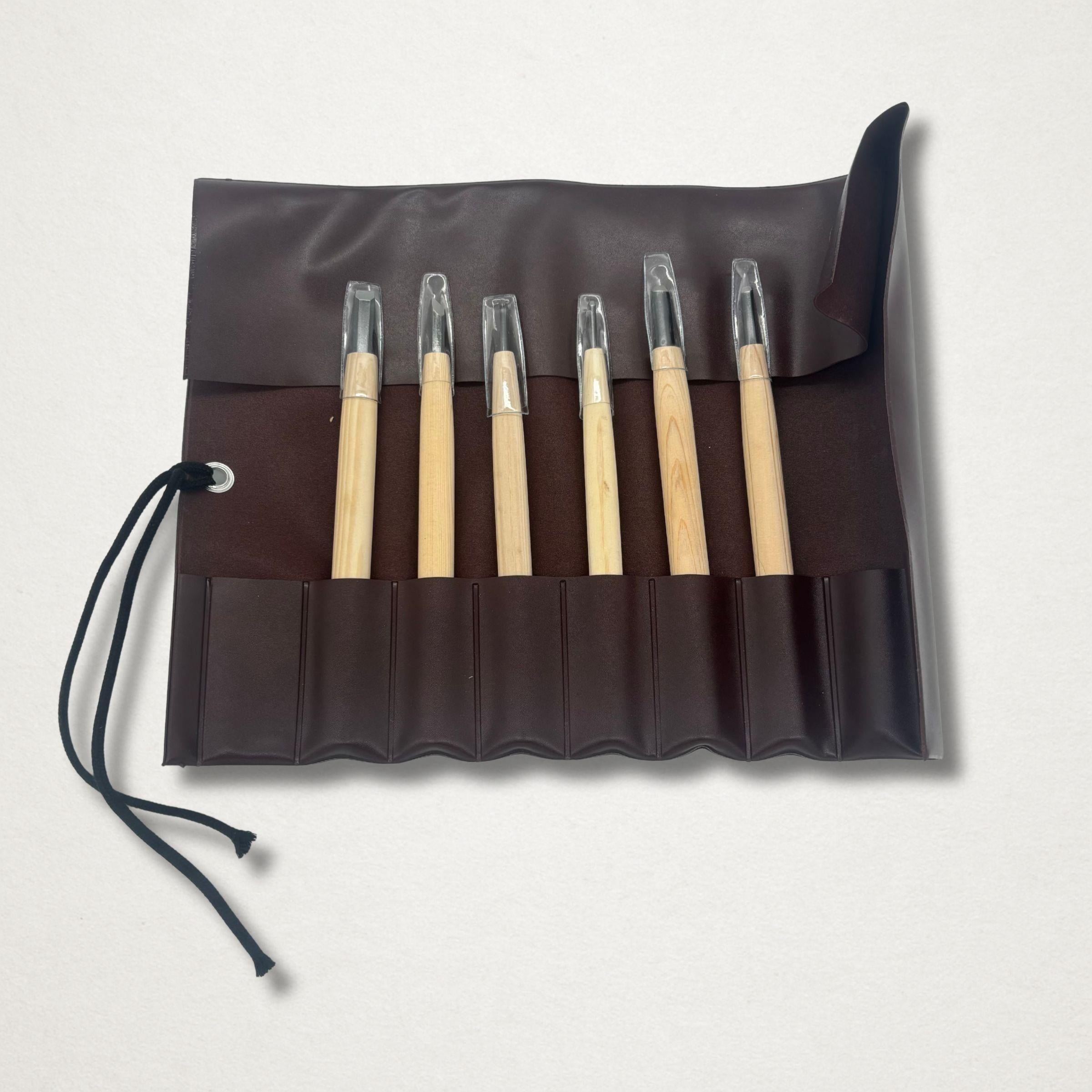 Michi Hamono Little Jizo carving kit tools displayed in an open dark brown tool roll on a light background