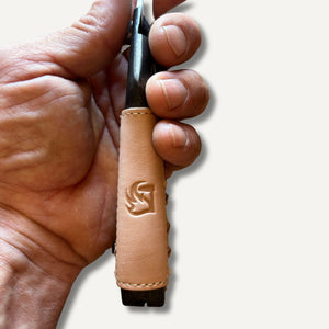 secateurs with leather grips and embossed logo held in hand