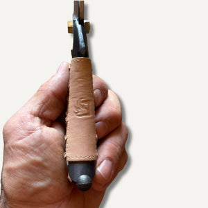 leather grip for secateurs with embossed logo held in hand