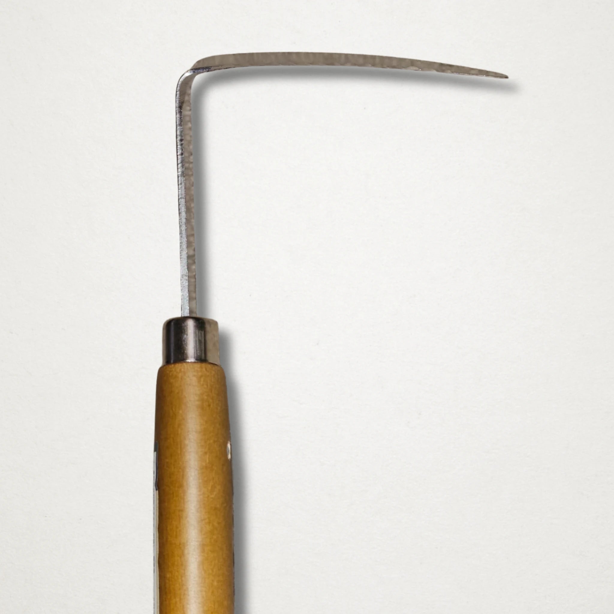 Close-up of Shozo stainless knock knock sickle blade and angled weeding head