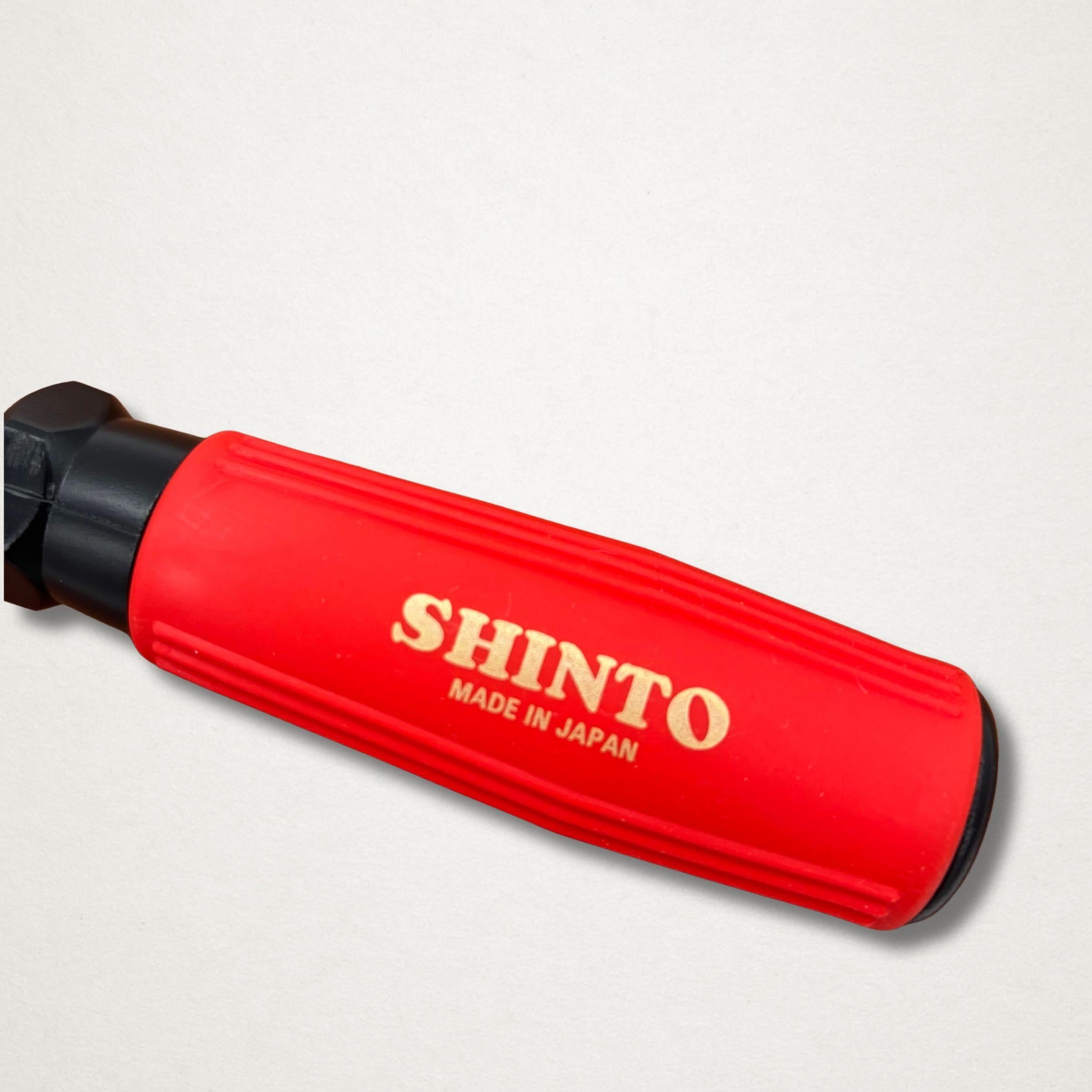 Close-up of the red Shinto handle with gold branding on a Japanese saw rasp