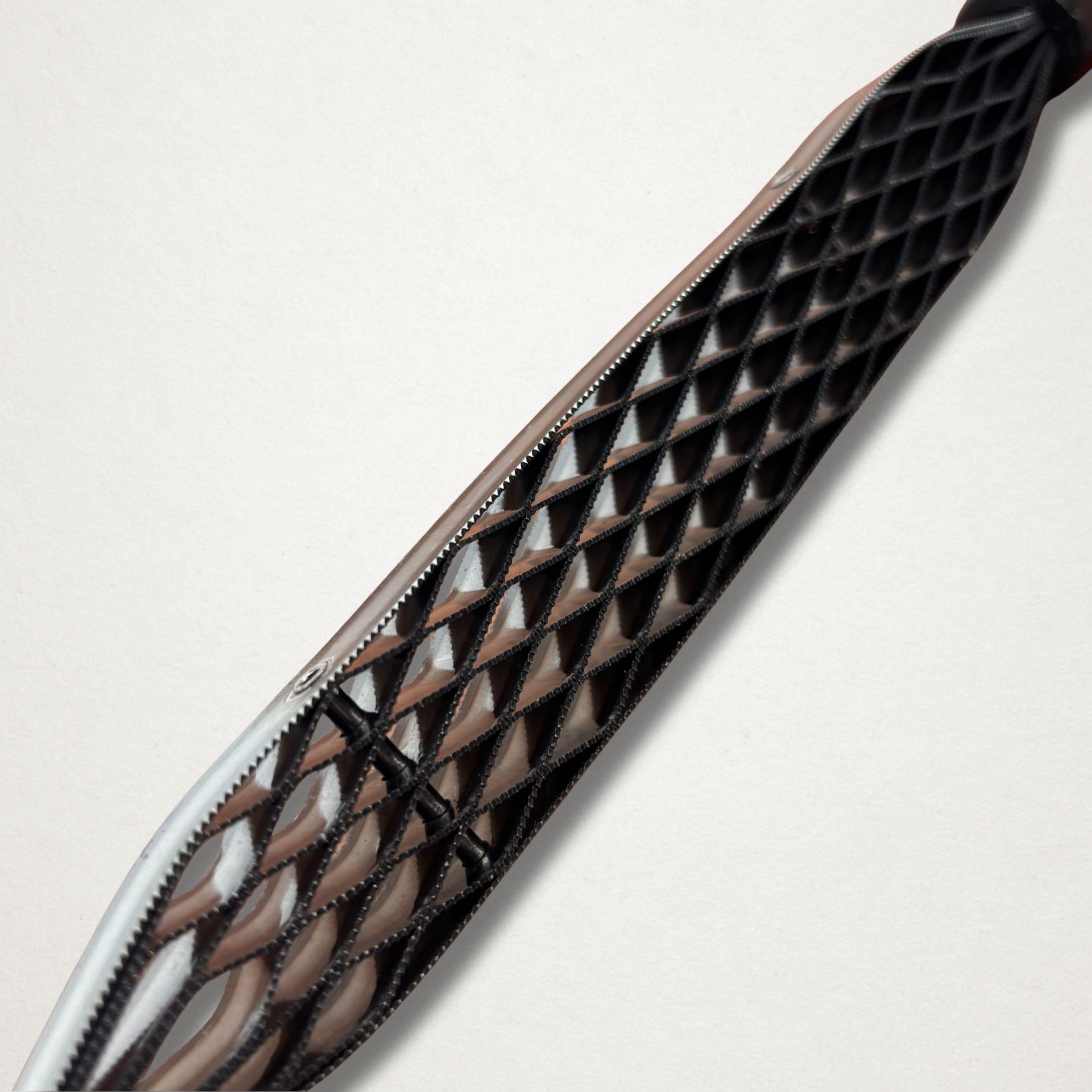 Angled close-up of the Shinto saw rasp teeth showing the raised cutting pattern