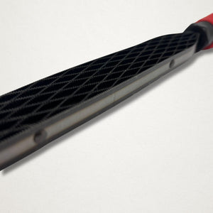 Low angle close-up of the Shinto saw rasp blade showing the steel side and tooth pattern