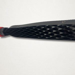 Close-up of the Shinto saw rasp blade showing the raised diamond tooth pattern near the handle