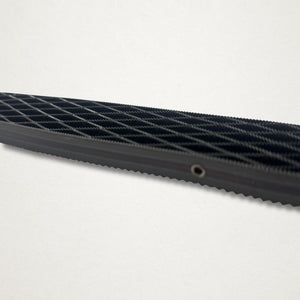 Close-up side view of the Shinto saw rasp blade showing the open lattice teeth and steel side plate