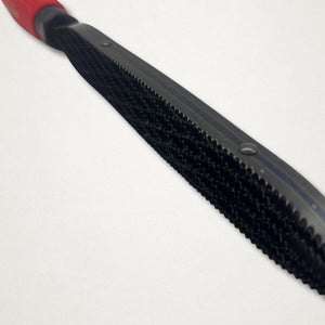 Angled close-up of the Shinto saw rasp blade showing the double-sided cutting pattern