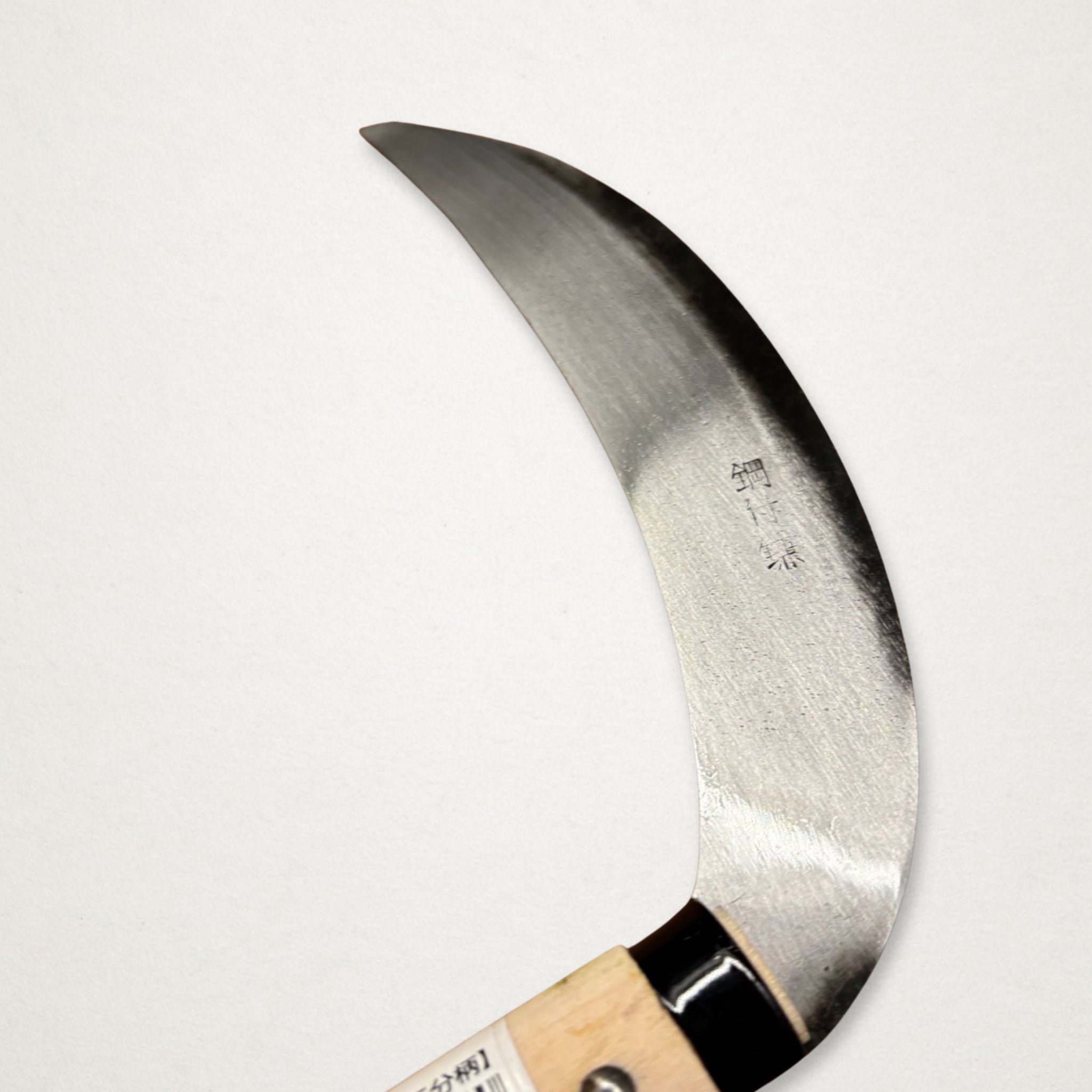 Close-up of Takemoto Kikumatsu left-handed garden tool head engraving and carbon steel edge