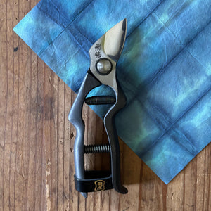 Tobisho Hirei pruning shears vertical on indigo-dyed washi paper background