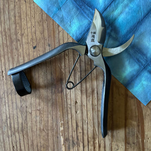 Tobisho Type-B 180mm Japanese pruning shears open on blue cloth background, Yasugi steel with upgraded leather strap lock
