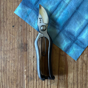 Tobisho Type-B 200mm Japanese pruning shears on indigo wash paper, compact hand-forged garden tool