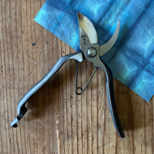 Tobisho Type-B pruning shears 200mm open position on indigo background, showing forged carbon steel blades