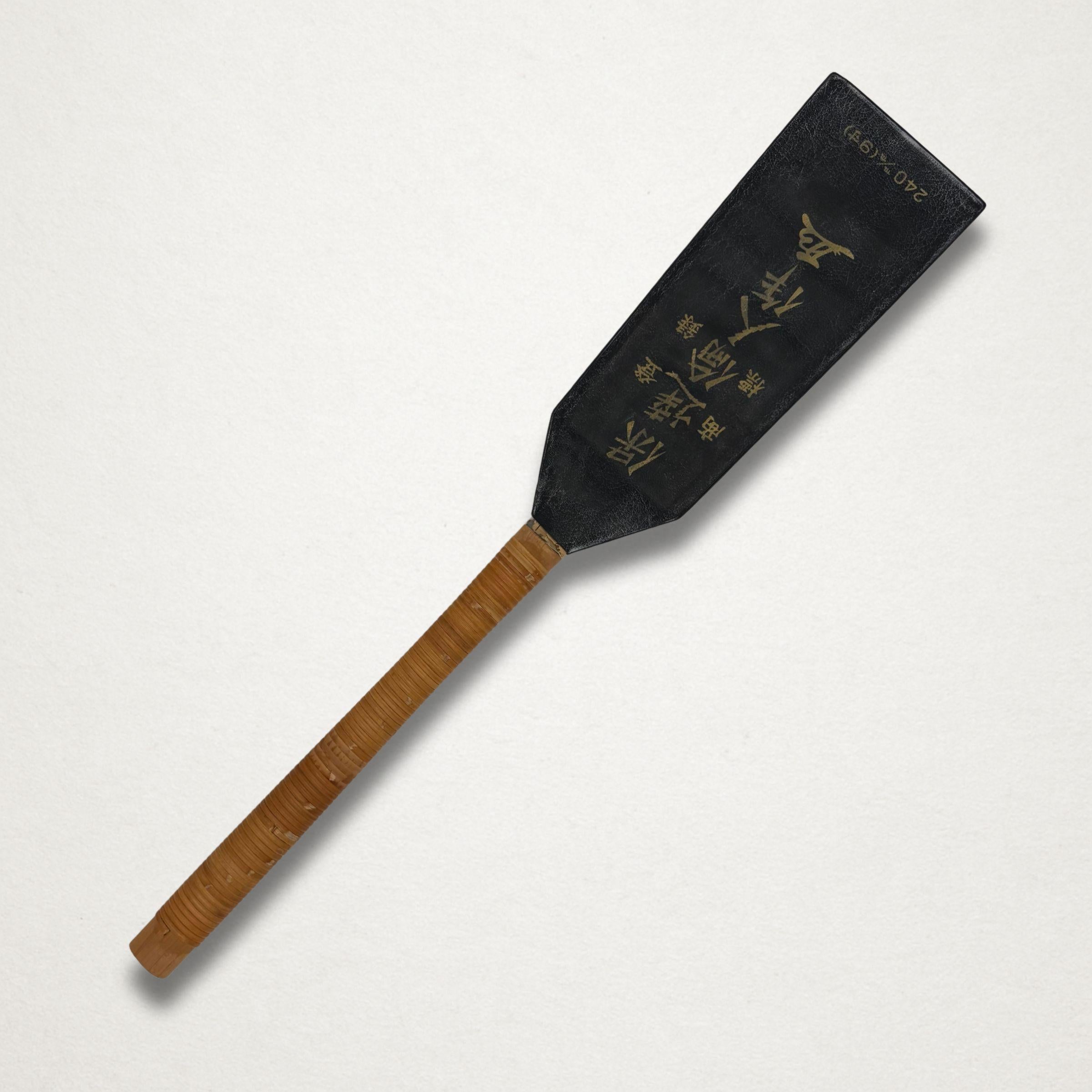 Japanese saw in black protective sheath on white background
