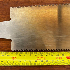 Close-up of the opposite side of the Japanese saw blade with ruler for size reference