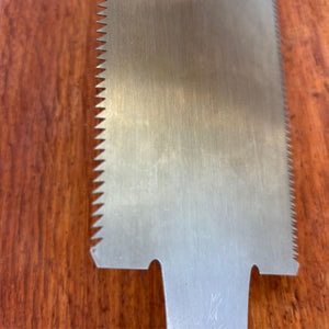 Close-up of the upper blade section showing tooth profile and steel surface