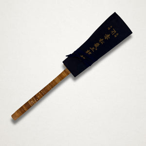 Full studio shot of vintage Japanese dozuki saw with wrapped rattan handle on white background