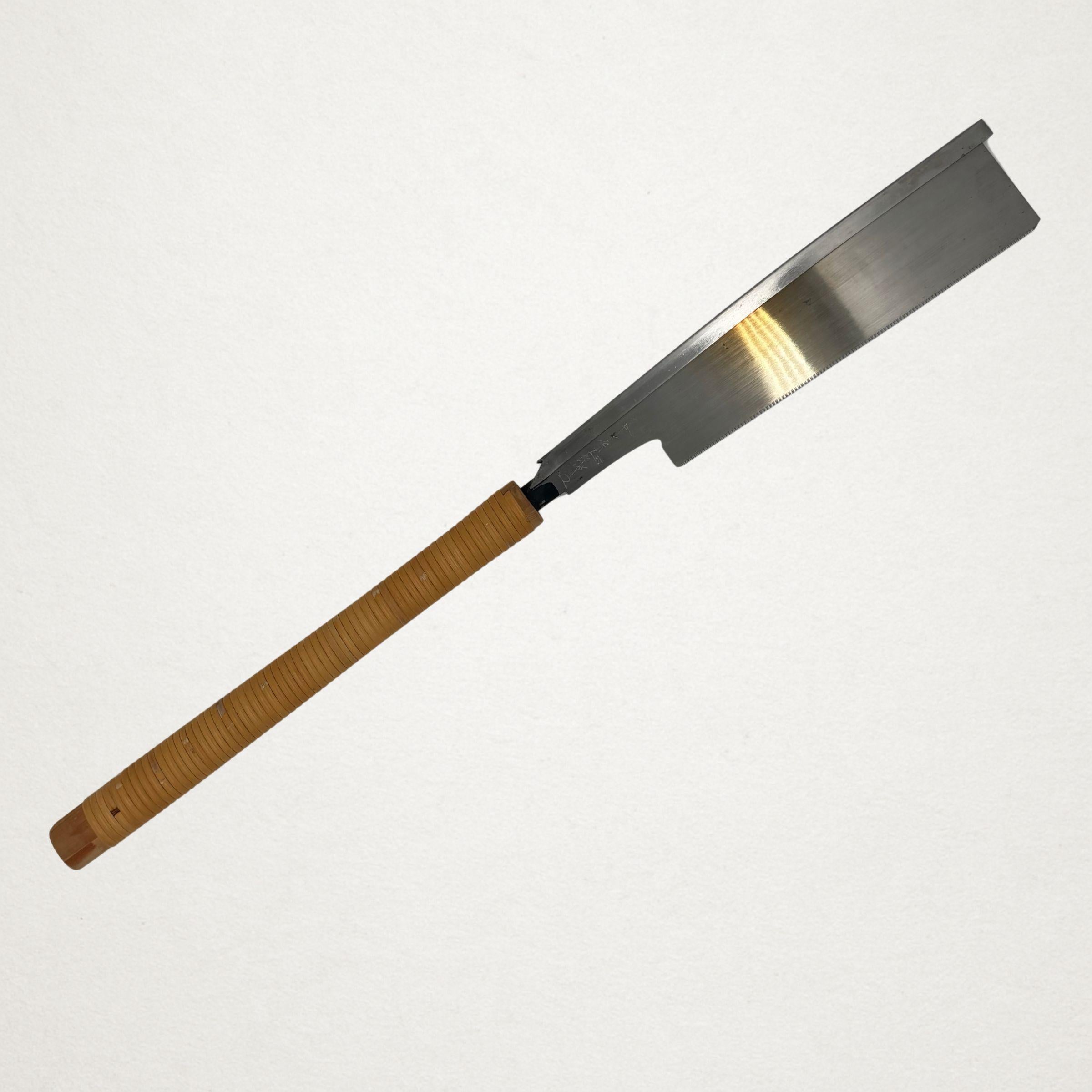 Side profile of a vintage 210mm Japanese dozuki saw with cane-wrapped handle
