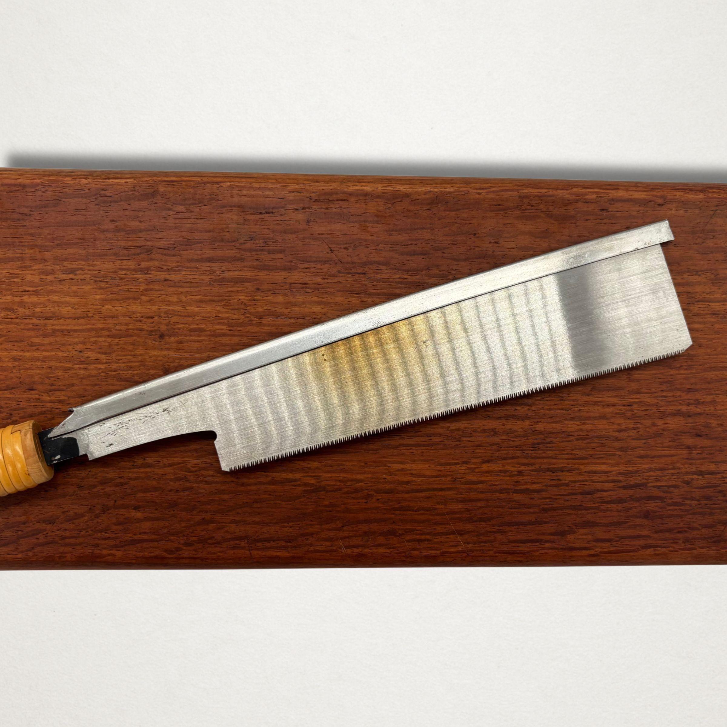 Full blade view of a vintage Japanese dozuki saw showing temper colour and backed spine