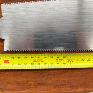  Close-up of 210mm blade beside tape measure showing tooth line and blade height