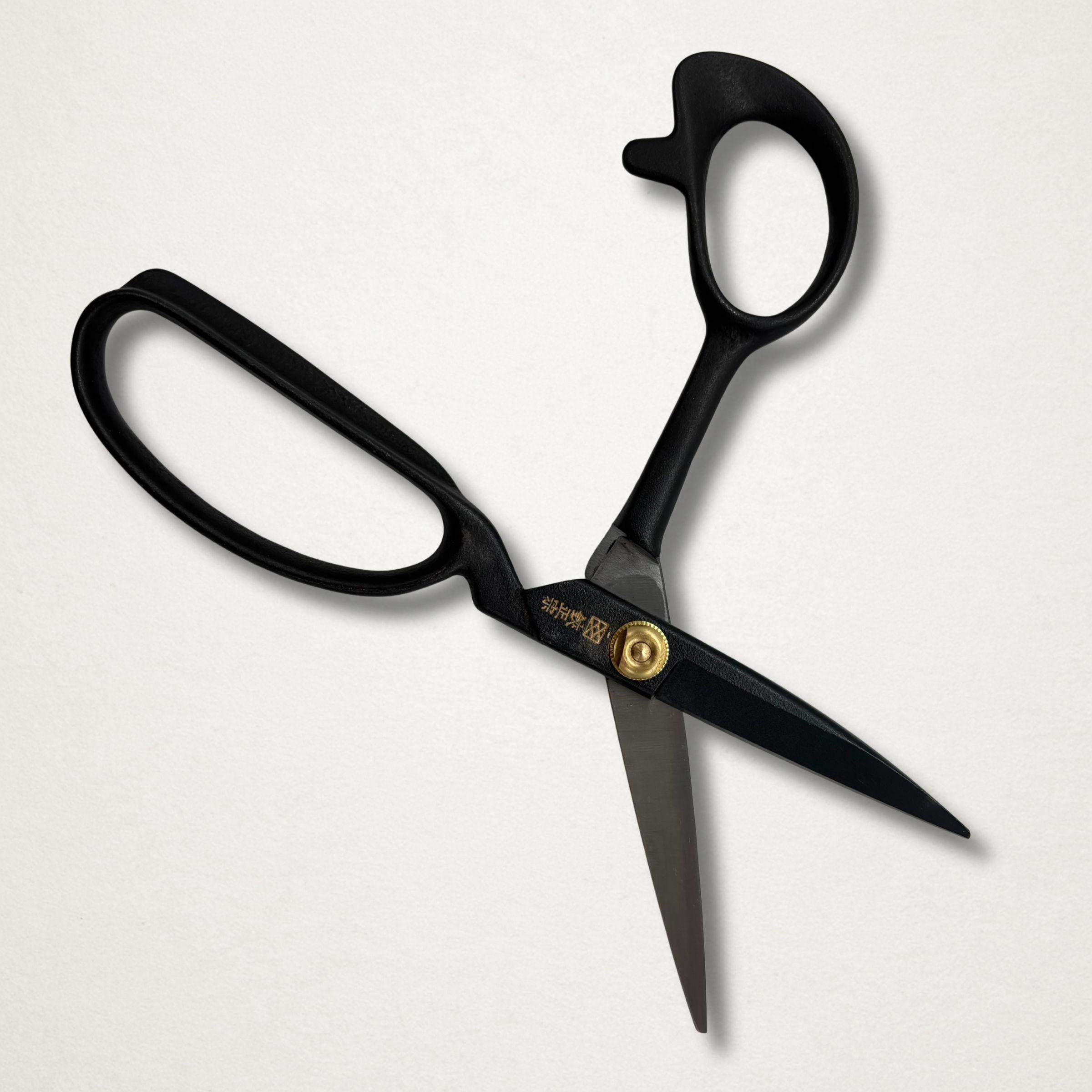 Black Japanese tailor scissors open on white background