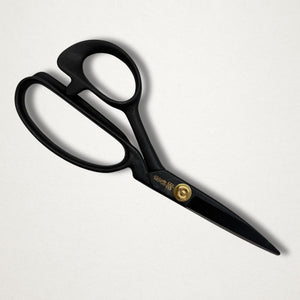 Black Masamune tailor scissors closed on white background
