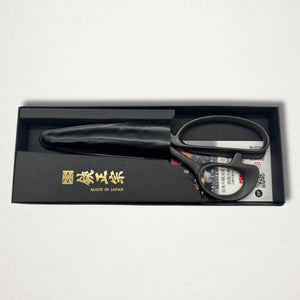 Black Japanese tailor scissors in presentation box with leather blade cover on white background