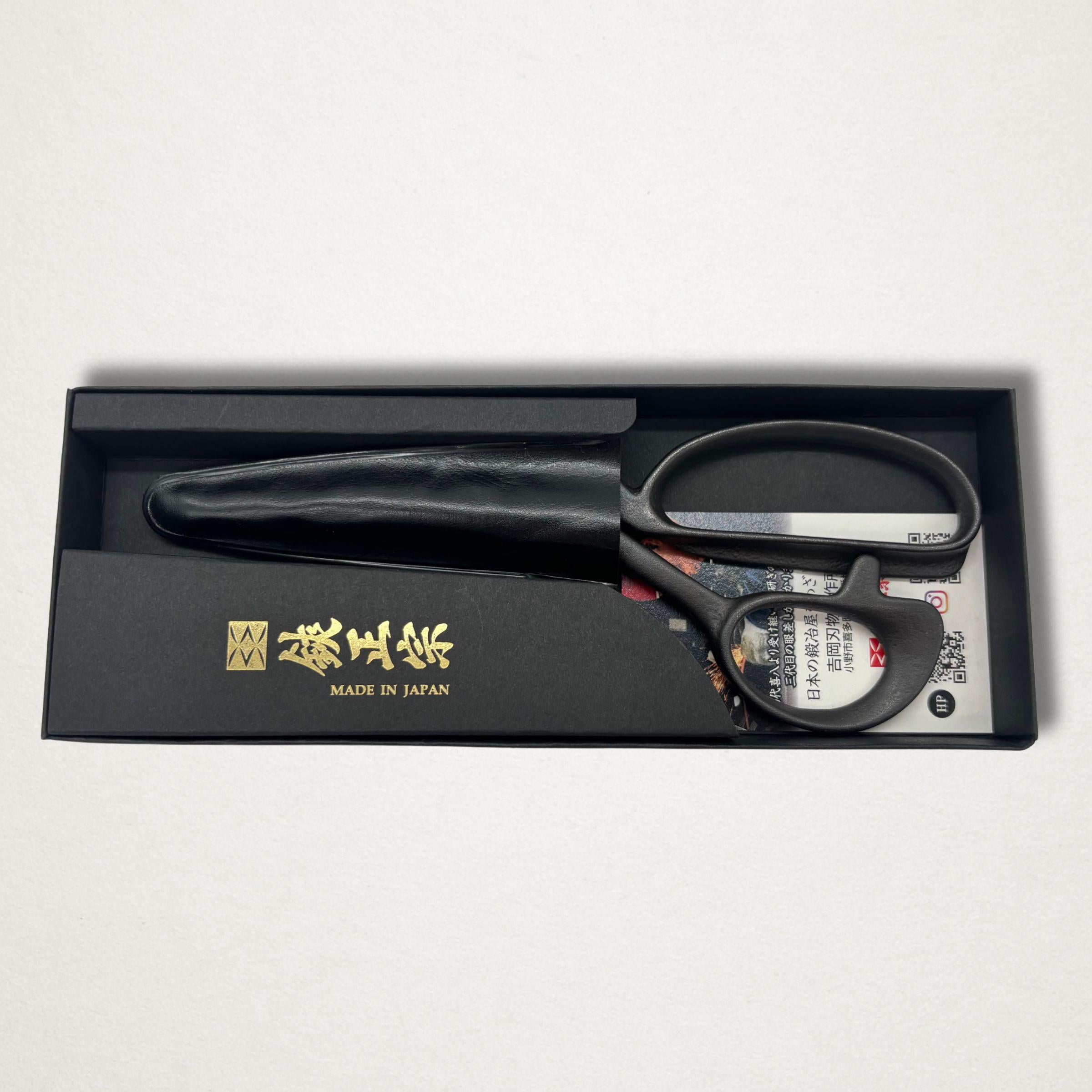 Black Japanese tailor scissors in presentation box with leather blade cover on white background