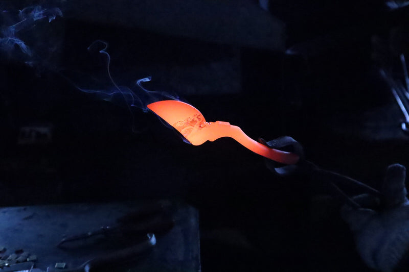 Freshly forged secateur blank smoking as it cools.