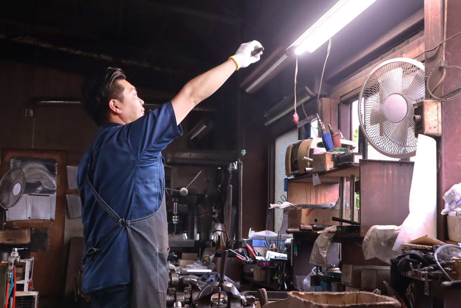 Tobisho craftsman performing final quality check and adjustment on a pair of forged secateurs in the Yamagata workshop.